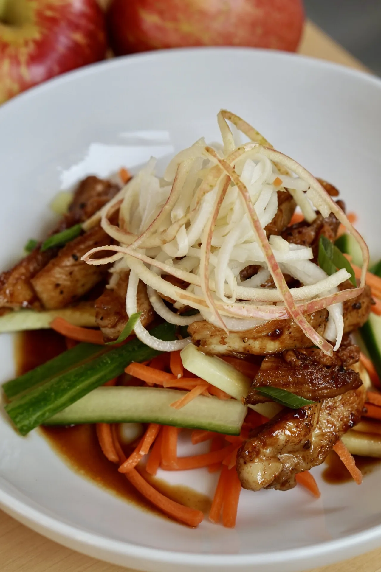 Pickled SweeTango apples and daikon on Korean BBQ chicken